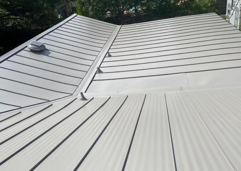 Solar attic fan installed on a metal roof for Roof Ventilation in Peppermill Village